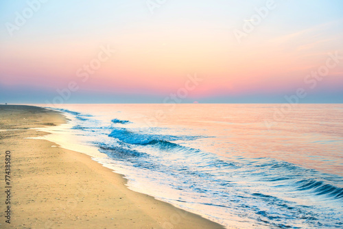Sunset on beach with sea waves  coastline  sun and dramatic sky