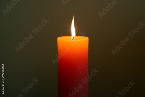 Candle light with flame on dark soft background © Pavlo Vakhrushev