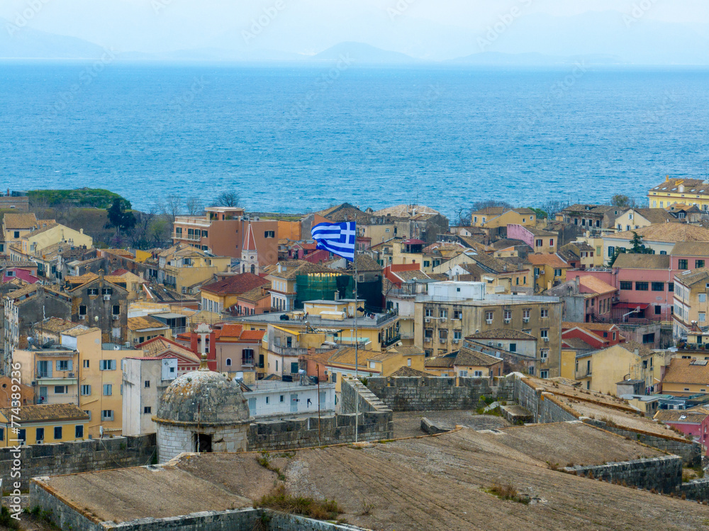 Aerial view of greek flag with corfu old fortress in background