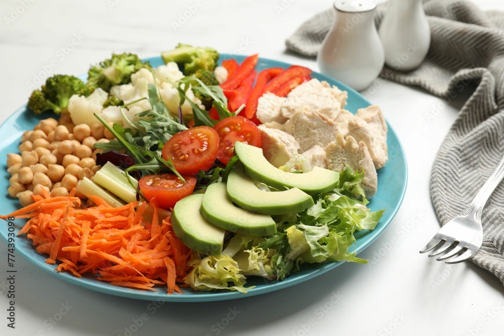 Balanced diet and healthy foods. Plate with different delicious products on white marble table Balanced diet and healthy foods. Plate with different delicious products on white marble table