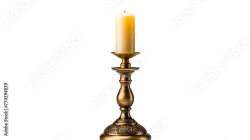 A single candle burning brightly in an ornate gold candle holder photo