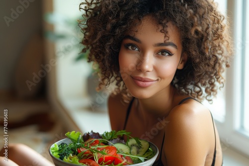 Ethnic Latin woman enjoying a fresh healthy salad at home