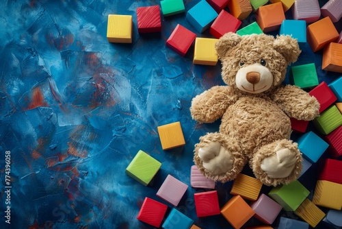 Background with toys teddy bear colorful blocks photo