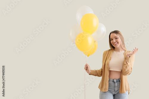 Young woman with balloons o...