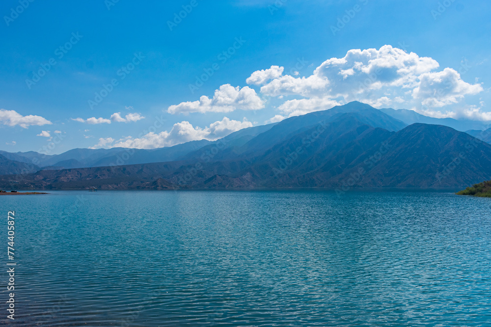 Lake Potrerillos in Mendoza, Argentina. Blue lake in the mountains with a beautiful sky