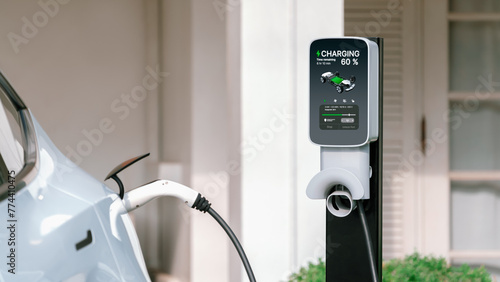 Electric vehicle technology utilized to residential home charging station for EV car battery recharge. Eco-friendly transport by clean and sustainable energy for future environment.Panorama Synchronos