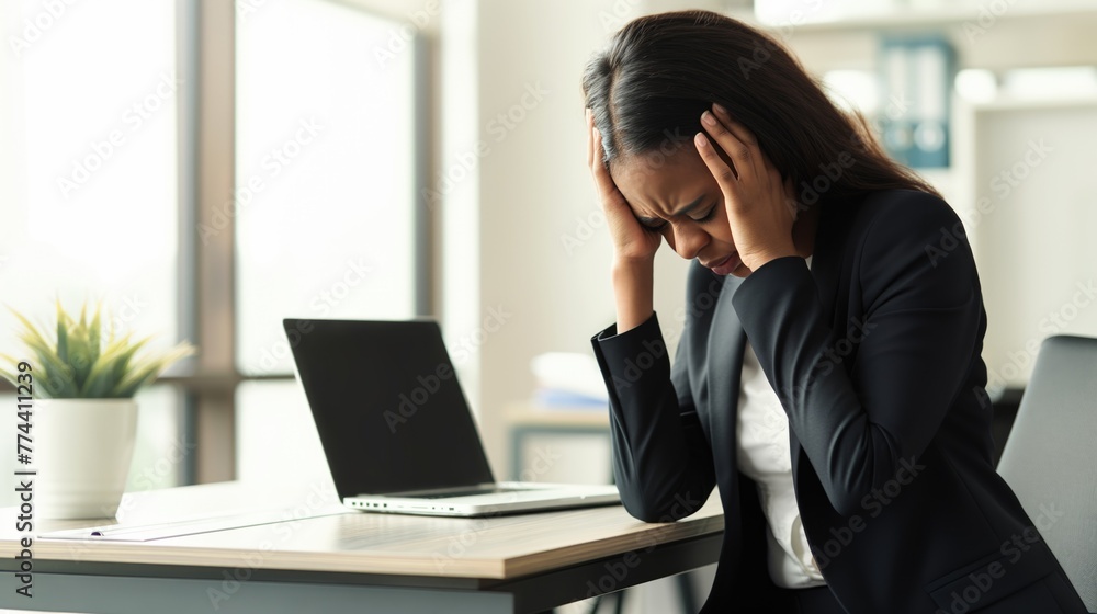 Office worker with tense neck muscles wearing having headache at work Office worker with tense neck muscles wearing having headache at work