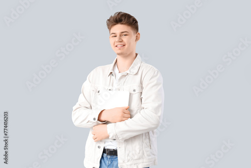 Young man with laptop on li...