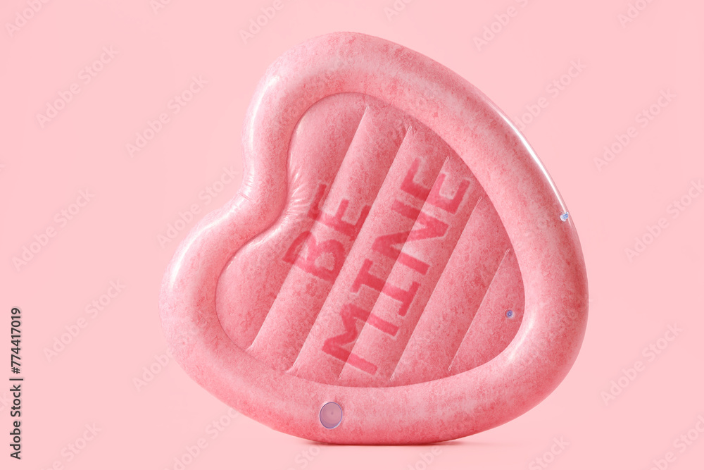 Swimming mattress in shape of heart on pink background Swimming mattress in shape of heart on pink background