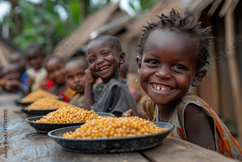 The problem of poverty and inequality. Happy african kids eating some sorghum porridge in village outdoor