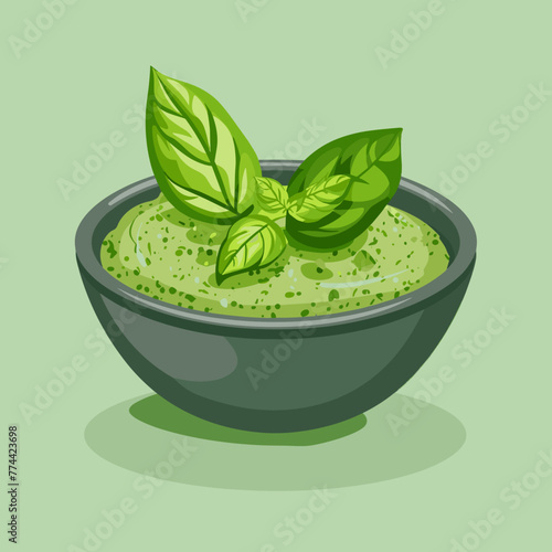 A bowl of green sauce Pesto with a leafy green herb on top