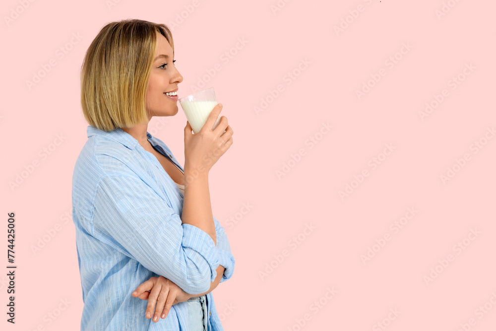 Beautiful young woman with glass of fresh milk on pink background Beautiful young woman with glass of fresh milk on pink background