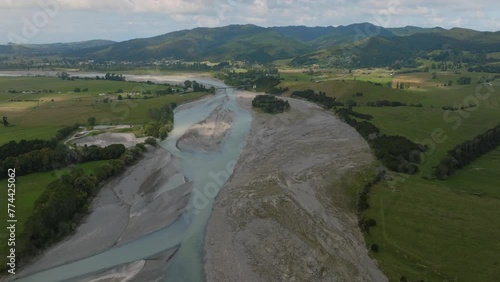 Aerial: Farmland and hill with erosion on the Waiapu River, Ruatoria, Gisborne, New Zealand. photo