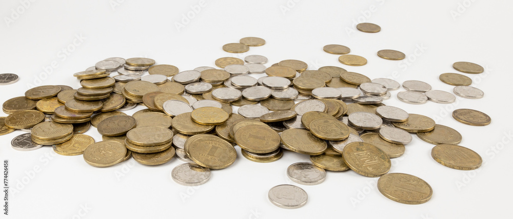 Scattered table coins, Ukrainian national currency, hryvnia. The concept of putting away baskets for old age. Scattered table coins, Ukrainian national currency, hryvnia. The concept of putting away baskets for old age.