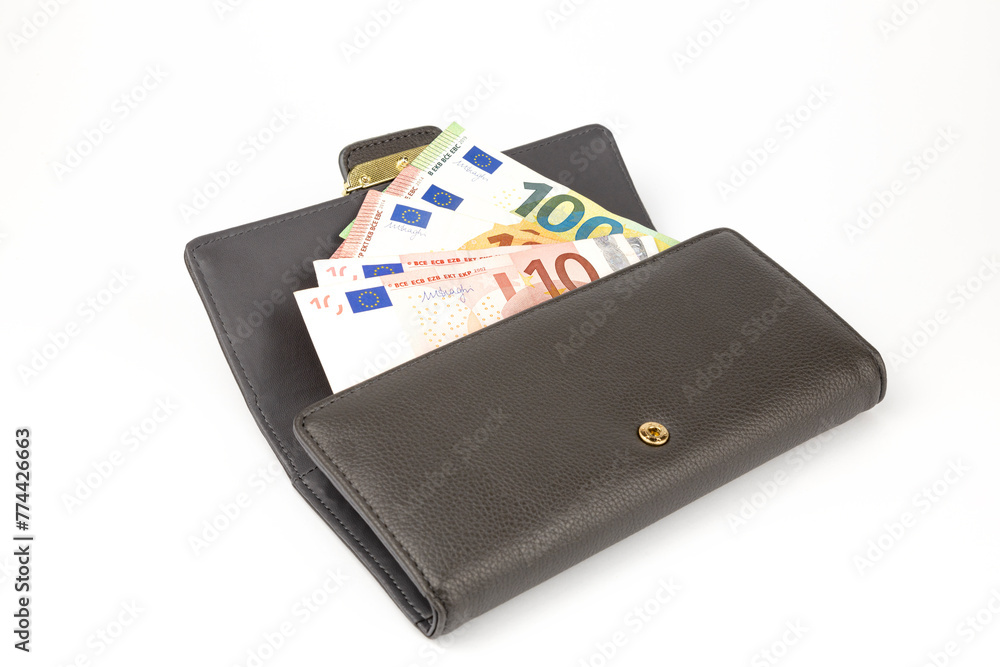 The leather wallet is stuffed with money. The concept of wealth and poverty. The leather wallet is stuffed with money. The concept of wealth and poverty.
