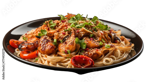 A plate of pasta loaded with a variety of perfectly cooked meat and colorful vegetables