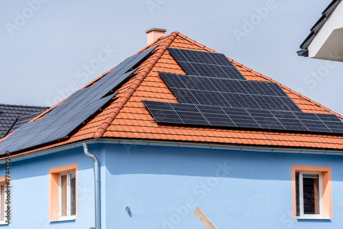 Solar panels producing clean energy on a roof of an old residential house, SHOTLISTeco