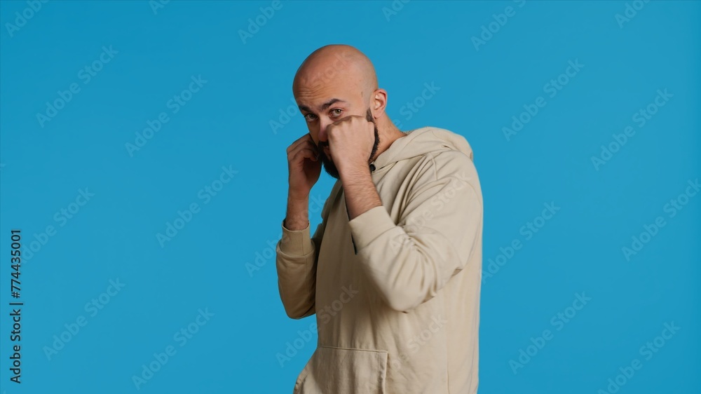 Muslim male model acting aggressive with clenched fists, preparing to fight and punch someone on camera. Arab person being violent and boxing in studio, strong man with fighter pose. Camera 1. Muslim male model acting aggressive with clenched fists, preparing to fight and punch someone on camera. Arab person being violent and boxing in studio, strong man with fighter pose. Camera 1.