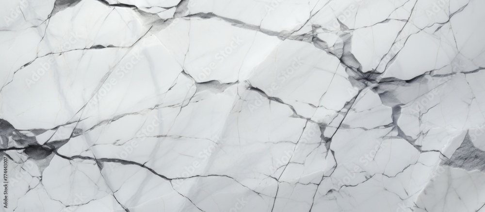 Detailed view of a white marble slab showing various intricate cracks and fractures on the surface