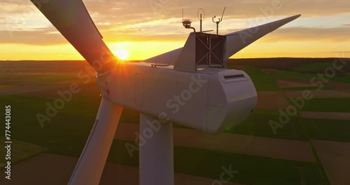 Establishing shot of windmills farm. Power energy production. Wind turbines. Large wind turbines with blades in field aerial view, sunset photo