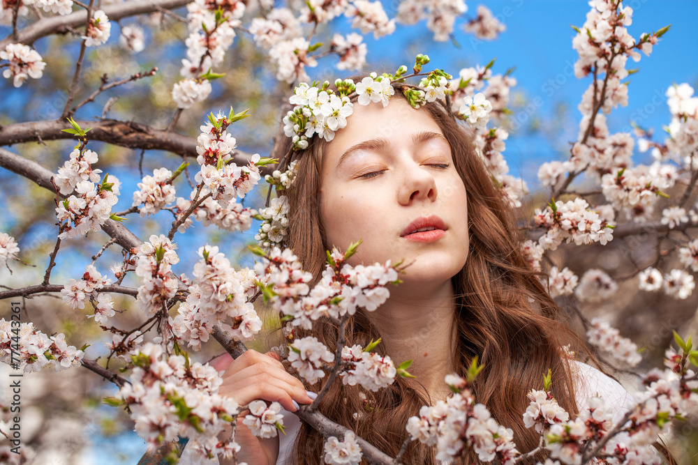 Young beautiful woman in a blooming garden Young beautiful woman in a blooming garden