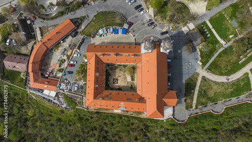 Tihanyi Benc  s Ap  ts  g  or the Benedictine Abbey of Tihany  is a historic monastery located in Tihany  Hungary  perched on a scenic hill overlooking Lake Balaton captured from a drone