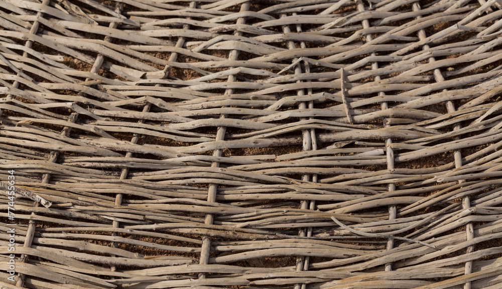 Weaving of twigs of branches. A man-made background smoldering on the ground. Weaving of twigs of branches. A man-made background smoldering on the ground.