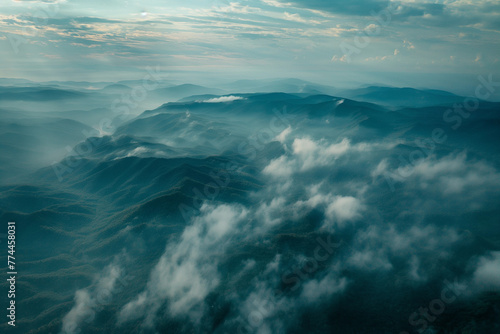 an aerial view of a foggy morning over a forest or mountain