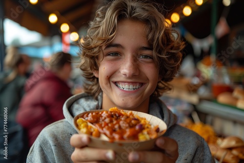 Joyful moment at a food market with a teenager enjoying a meal