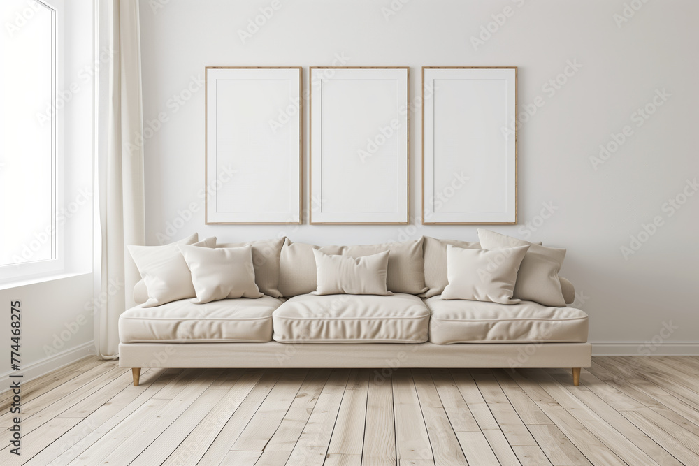 A white couch with three empty frames on the wall.