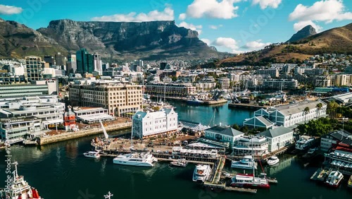 Aerial drone hyperlapse view of Bustling Victoria and Alfred Waterfront in Cape Town, South Africa on a Clear Day with Table Mountain and CBD Cape Town in background photo