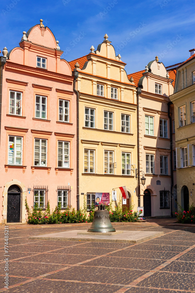 Cityscape - view of the Canonicity Square with the Warsaw Bell, bronze bell mounted on a pedestal, in the Old Town of Warsaw, Poland