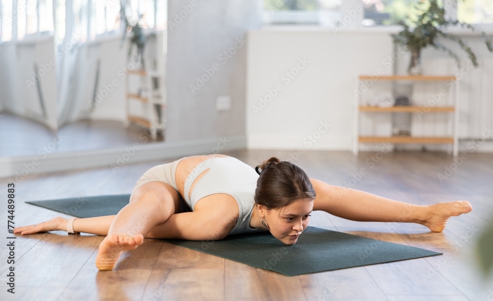 Young girl couch train during hatha yoga class, perform exercises and stretches to improve physical health. Teacher working out practice Supt Kurmasan