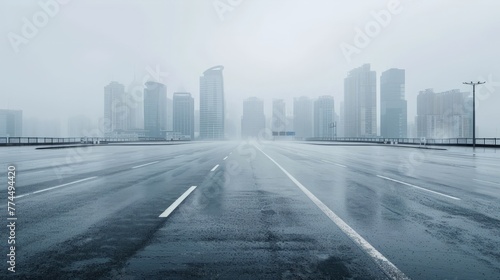 Empty wet asphalt road with foggy city skyline background   raining day .