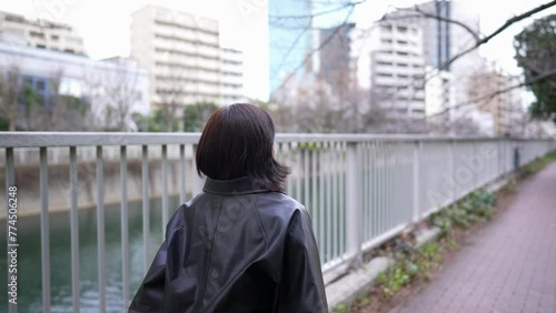 A Japanese woman in her 20s walking on the road around Gotanda Station, Shinagawa-ku, Tokyo in winter 冬の東京都品川区五反田の駅周辺の道を歩く２０代の日本人女性  photo