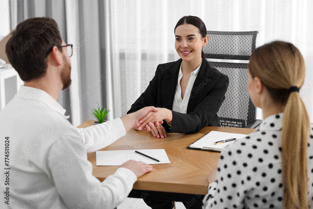 Lawyer shaking hands with clients in office Lawyer shaking hands with clients in office
