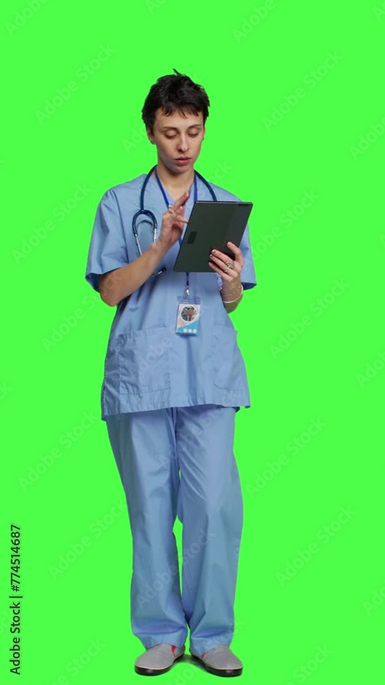 Front view Nurse doing online shopping with credit card banking transaction, paying for items on store website. Medical assistant purchasing things on internet, e commerce ordering against greenscreen Front view Nurse doing online shopping with credit card banking transaction, paying for items on store website. Medical assistant purchasing things on internet, e commerce ordering against greenscreen