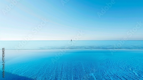 A pristine pool reflects the clear blue sky, its surface undisturbed by ripples or waves. photo