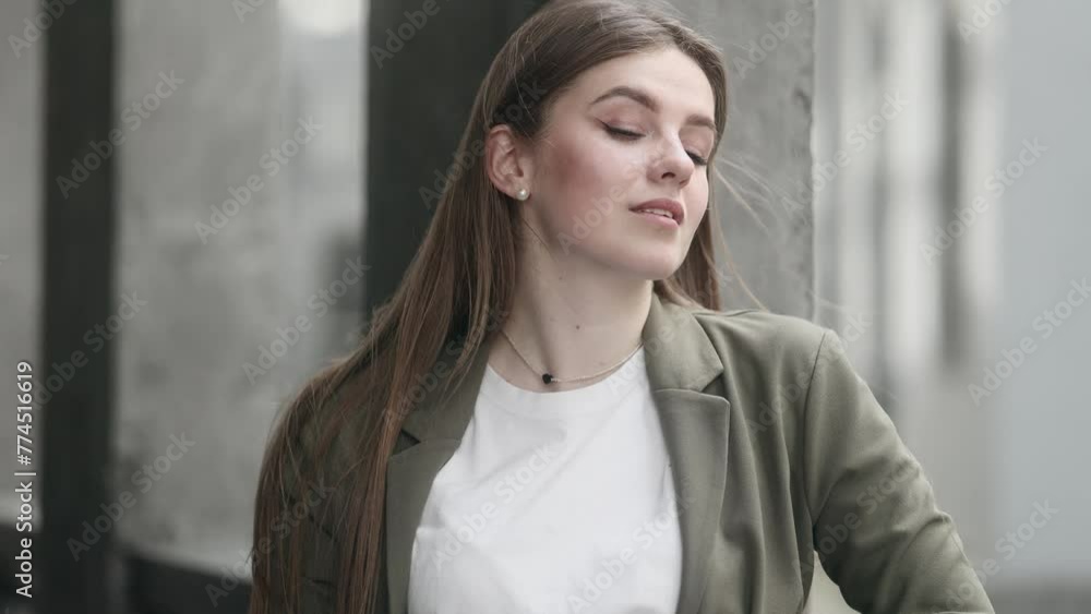 Thoughtful young pretty businesswoman after hard work day near modern business centre Beautiful stylish woman worker relaxing and looking ahead outside Thoughtful young pretty businesswoman after hard work day near modern business centre Beautiful stylish woman worker relaxing and looking ahead outside