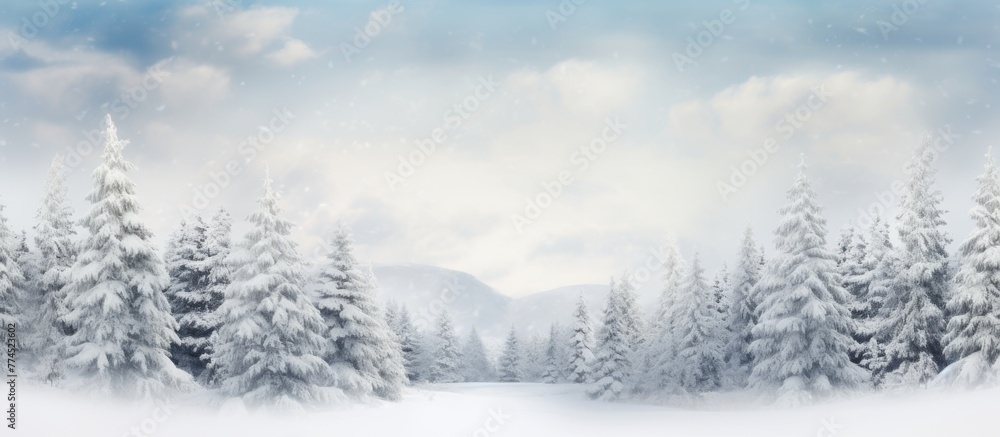 Scene of snow-covered trees in a winter wonderland against a clear blue sky backdrop, creating a serene and picturesque view