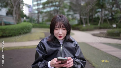 A Japanese woman in her 20s who speaks sign language around Gotanda Station, Shinagawa-ku, Tokyo in winter 冬の東京都品川区五反田の駅周辺で手話で話す２０代の日本人女性 photo