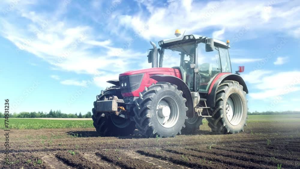 Farm tractor in the field under blue sky with white clouds Farm tractor in the field under blue sky with white clouds