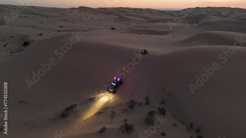 Offroading through the desert at dusk photo