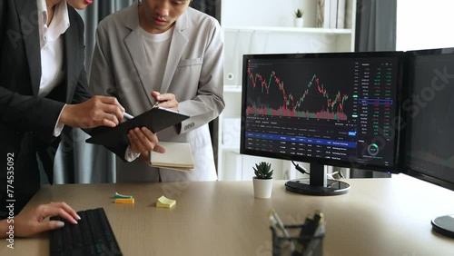 Slow motion business investors in stock trading company analyzing stock exchange marketing looking at monitors analyzing candle bar price for loss and grow up gain and profits. Burgeoning photo