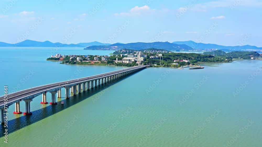 Aerial video of highway road and lake with mountains natural landscape in Taihu, Suzhou. Drone surround shooting. Aerial video of highway road and lake with mountains natural landscape in Taihu, Suzhou. Drone surround shooting.