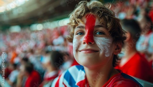 A young boy with a red nose. Football fan at the football championship