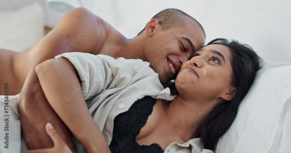 Happy couple, relax and kissing on bed for embrace, love or morning romance in trust or care at home. Young man and woman smile lying in bedroom hug for intimacy, passion or bonding together at house Happy couple, relax and kissing on bed for embrace, love or morning romance in trust or care at home. Young man and woman smile lying in bedroom hug for intimacy, passion or bonding together at house