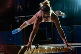 Female gymnast doing balance exercise in gym