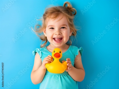 Happy child with yellow rubber duc  photo