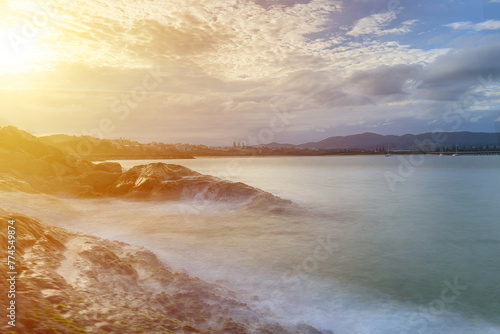  colorful evening sunset over the rocky coastal line.